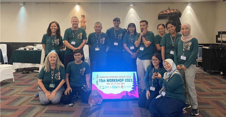 Individuals from OVAG 2023 pose with the 2023 poster.